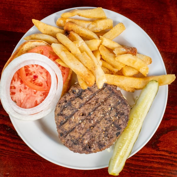 Bullwinkle's Top Hat Bistro's BBQ burger with fries, tomato, onion, and a pickle spear.